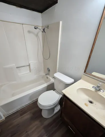 a bathroom with a toilet a sink and bathtub