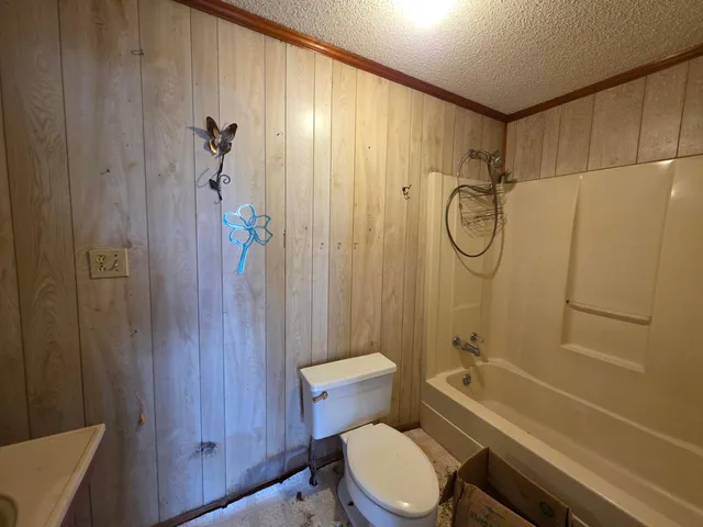 a bathroom with a toilet a sink and shower