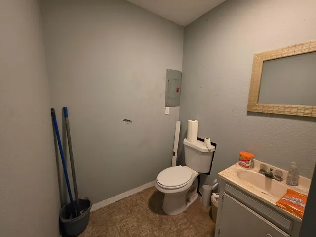 a white toilet sitting next to a bathroom sink