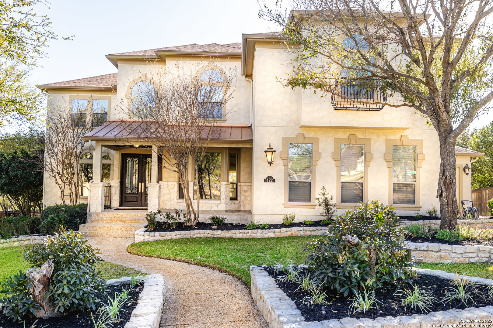 a front view of a house with garden