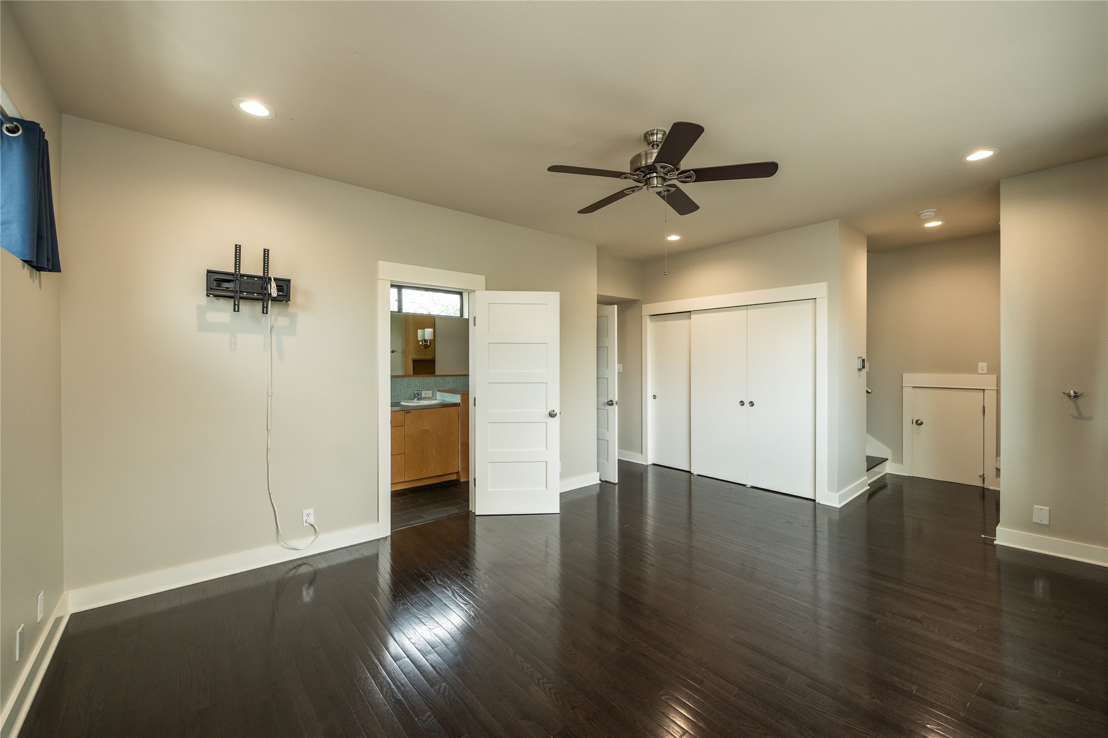 2103 Kinney Avenue Austin, TX 78704 - Photo 27 of 40 Primary bedroom features dark hardwood floors, light-colored walls, and a ceiling fan with integrated lighting