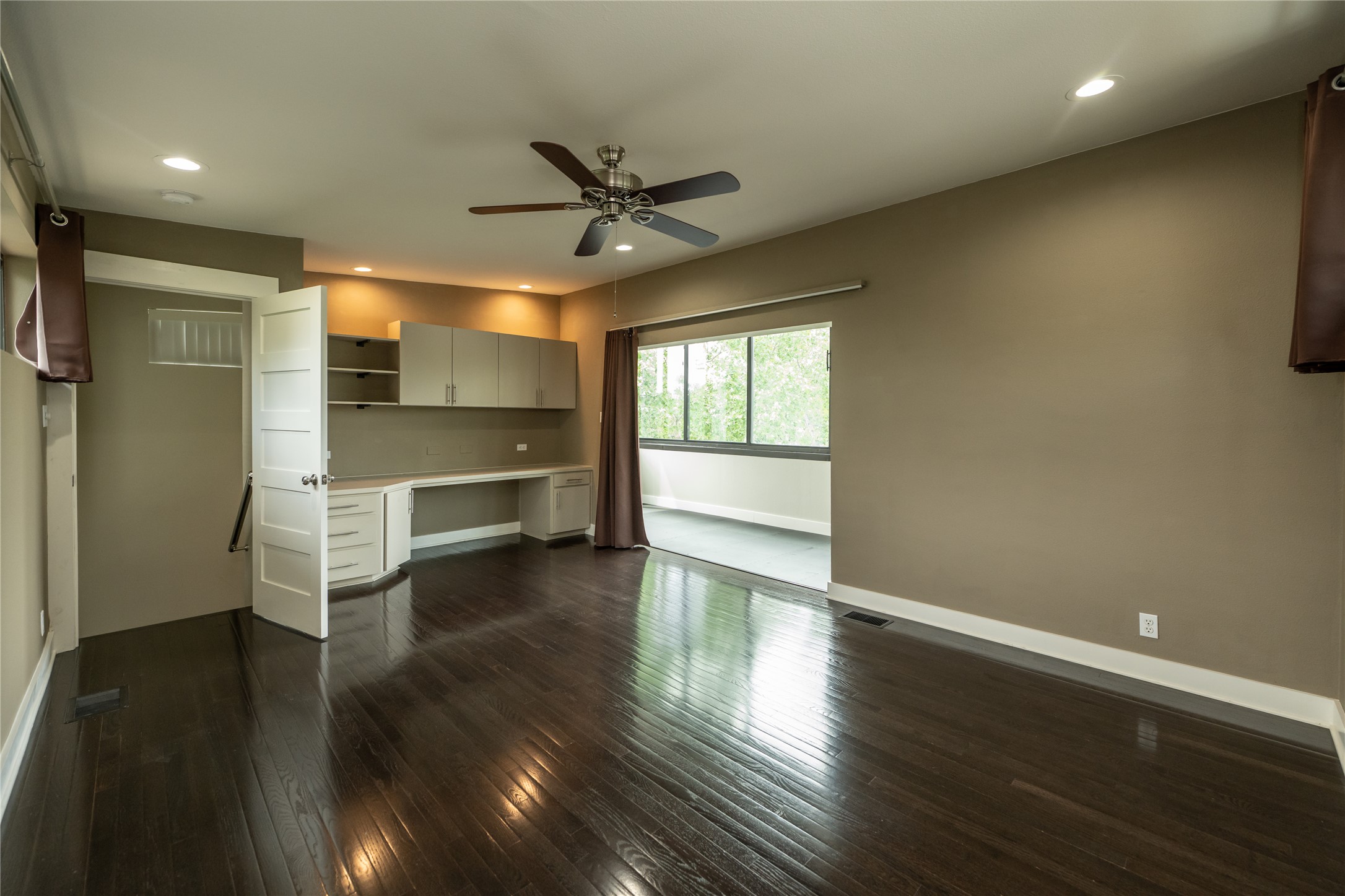 2103 Kinney Avenue Austin, TX 78704 - Photo 33 of 40 This spacious and versatile room features dark hardwood floors and recessed lighting. It could be used for a home office, home gym, media room, or whatever your heart desires.