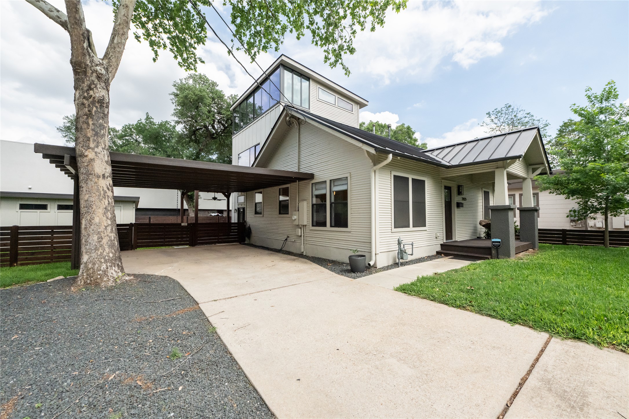 2103 Kinney Avenue Austin, TX 78704 - Photo 4 of 40 Covered carport, a well-maintained lawn, and a distinct upper level with large windows