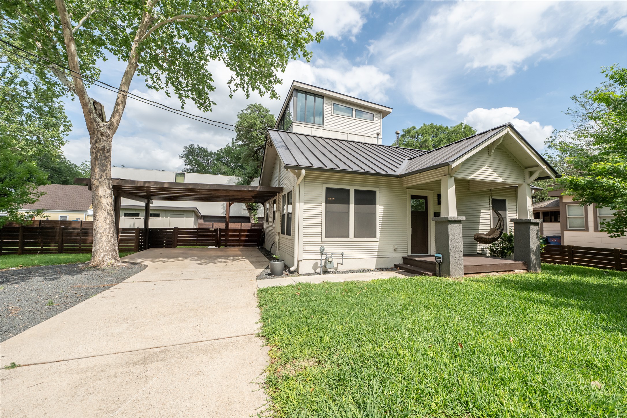 2103 Kinney Avenue Austin, TX 78704 - Photo 5 of 40 Well-maintained lawn, concrete driveway, and a covered parking area