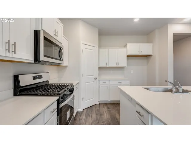 a open kitchen with kitchen island a sink stove and refrigerator