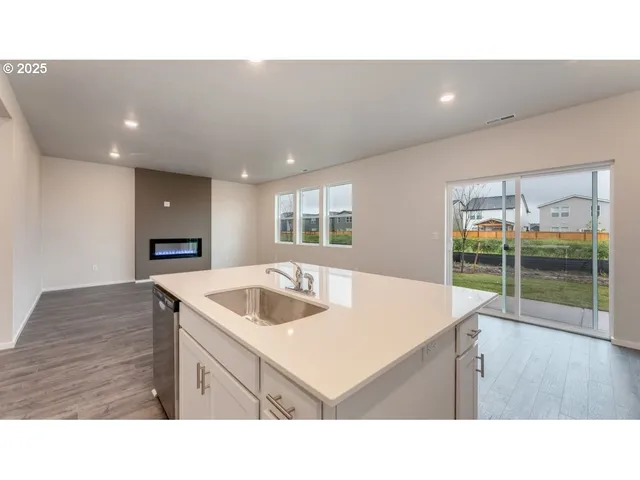 a kitchen with a sink a stove and cabinets