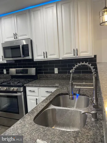 a kitchen with a sink and a stove