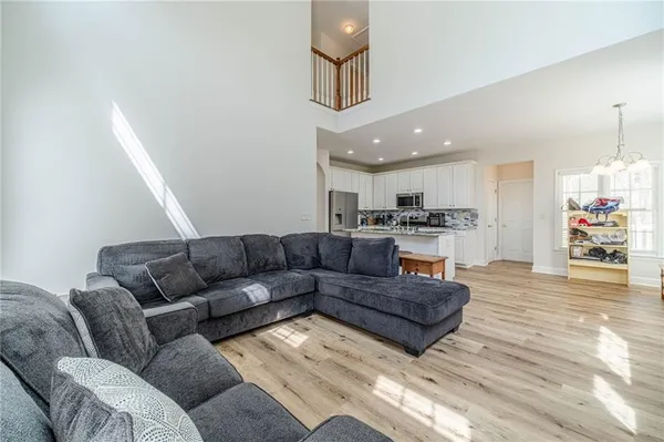a living room with furniture large window and fireplace
