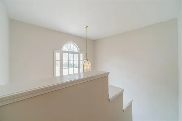 an empty room with a ceiling fan and a window