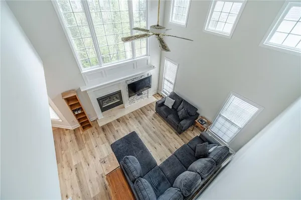 an empty room with windows and ceiling fan