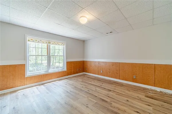 a view of a room with wooden floor and a window