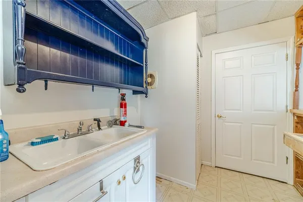 a picture of a bathroom with a sink a mirror and shower