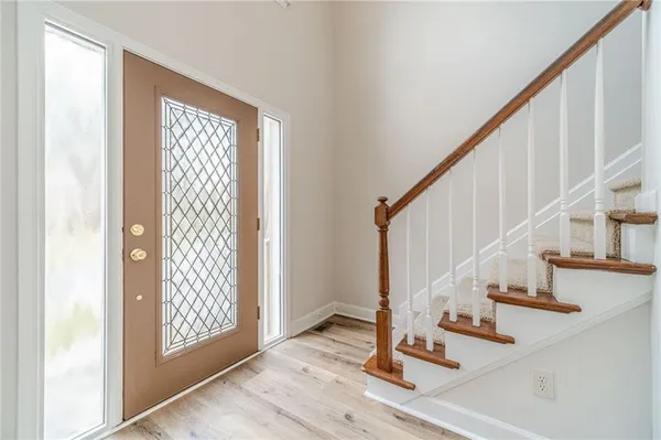 a view of a livingroom with wooden floor and stairs