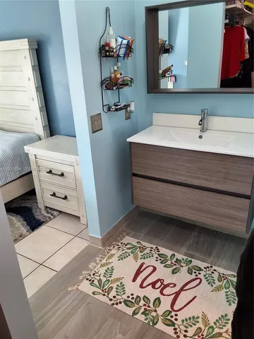 a bathroom with a sink a vanity and a mirror