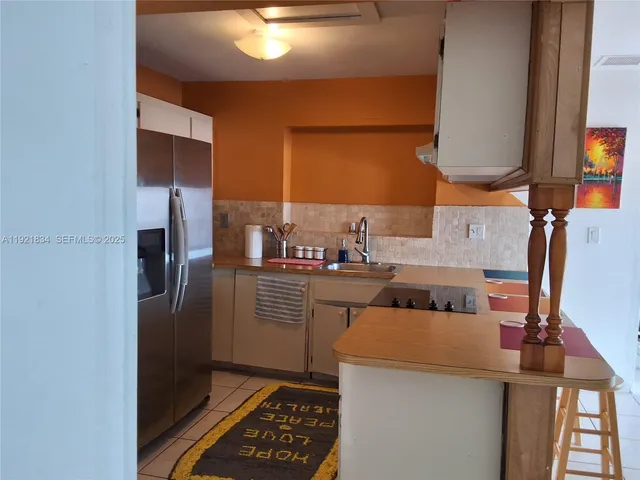 a kitchen with a refrigerator and a sink