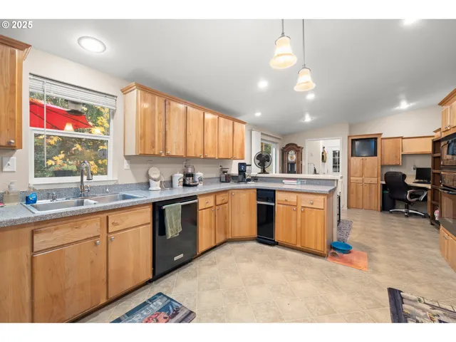 a kitchen with granite countertop a refrigerator stove and microwave