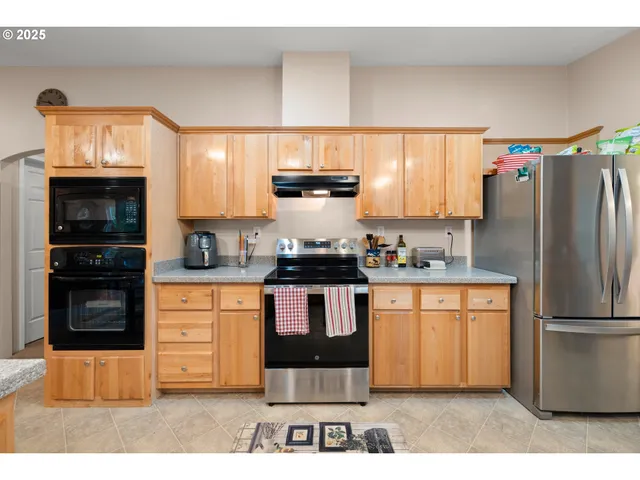 a view of a dining room with furniture a chandelier and wooden floor