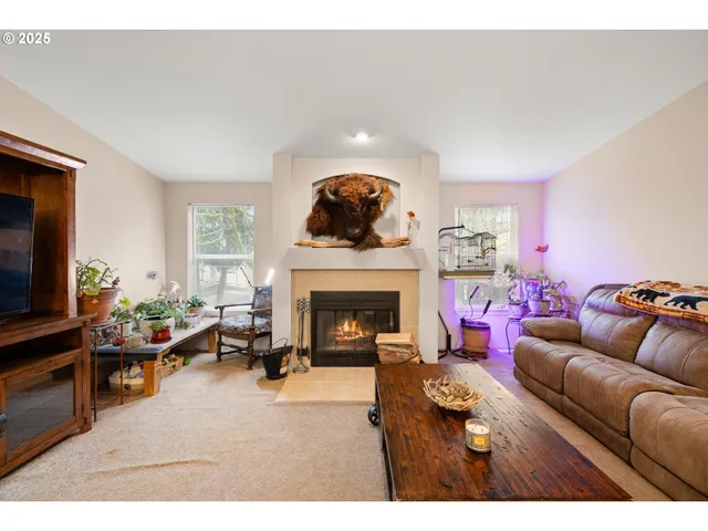 a living room with a bed and a flat screen tv