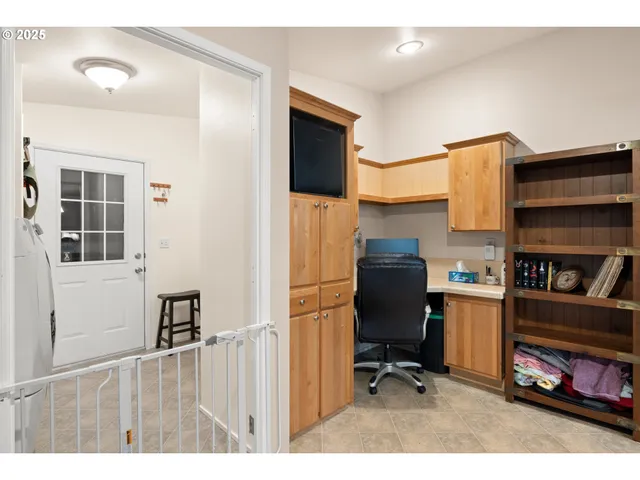 a dining room with furniture and a floor to ceiling window