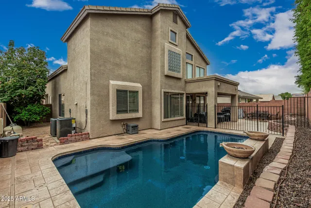 a view of house with swimming pool outdoor seating