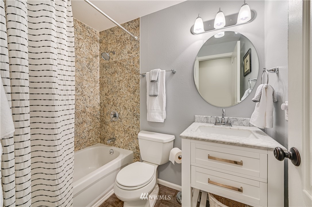 116 East Jonathan Road Bothell, WA 98012 - Photo 13 of 27 a bathroom with a toilet sink vanity tub and mirror