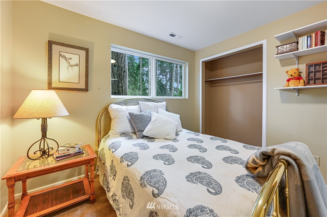 116 East Jonathan Road Bothell, WA 98012 - Photo 14 of 27 a bedroom with a bed and a lamp