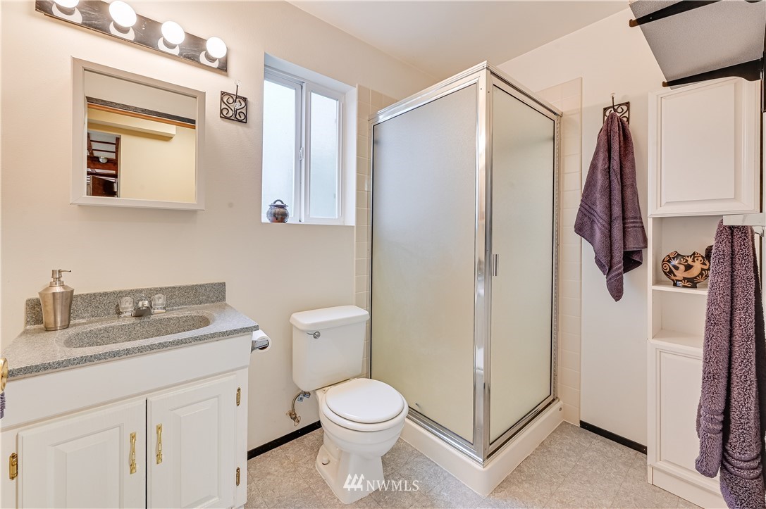 116 East Jonathan Road Bothell, WA 98012 - Photo 15 of 27 a bathroom with a granite countertop sink toilet and shower