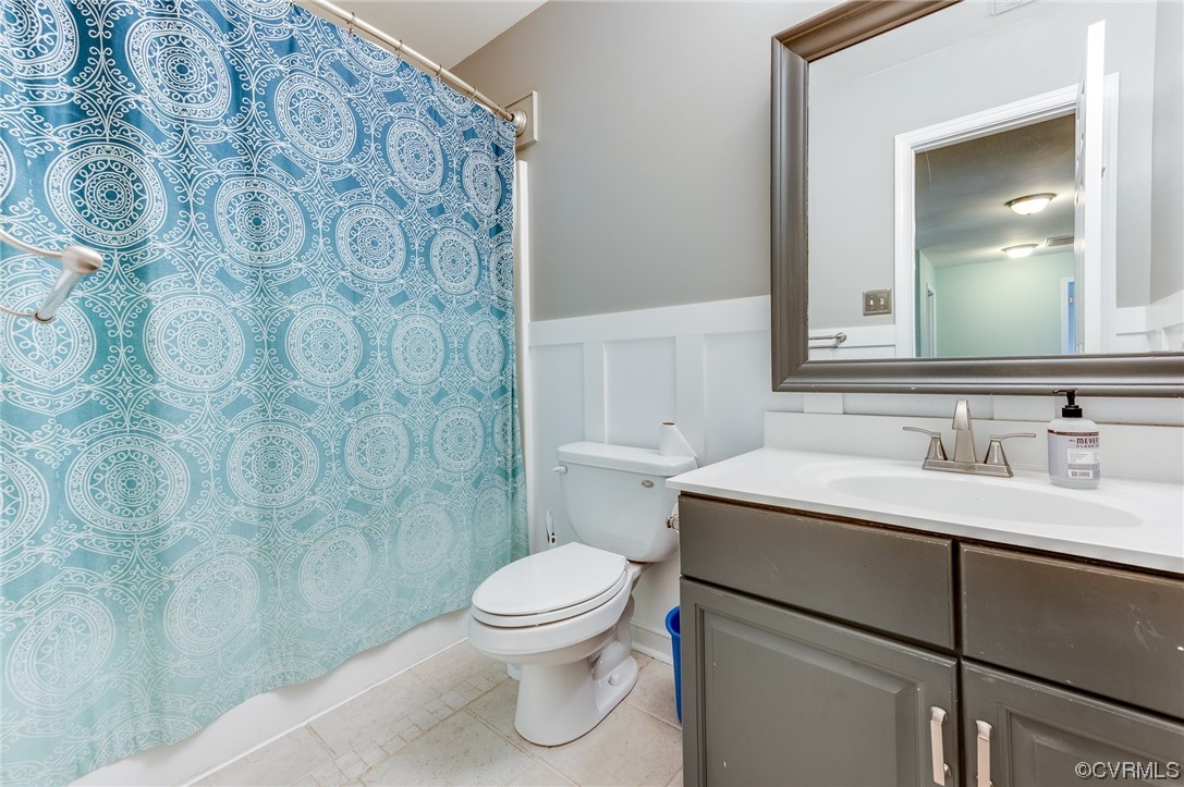 12118 Club Ridge Drive Chester, VA 23836 - Photo 25 of 38 Bathroom with Updated tile floors, mirror, toilet, large vanity