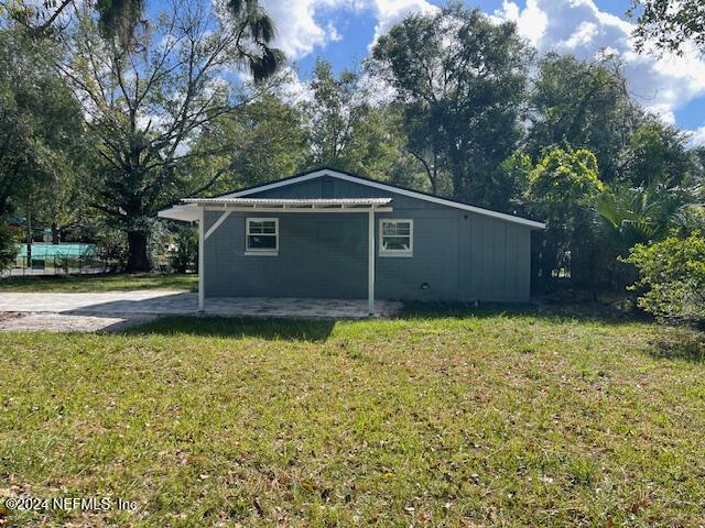 7301 Melvin Road Jacksonville, FL 32210 - Photo 23 of 27 a backyard of a house with lots of green space