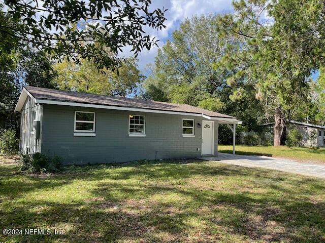 7301 Melvin Road Jacksonville, FL 32210 - Photo 25 of 27 a backyard of a house with lots of green space