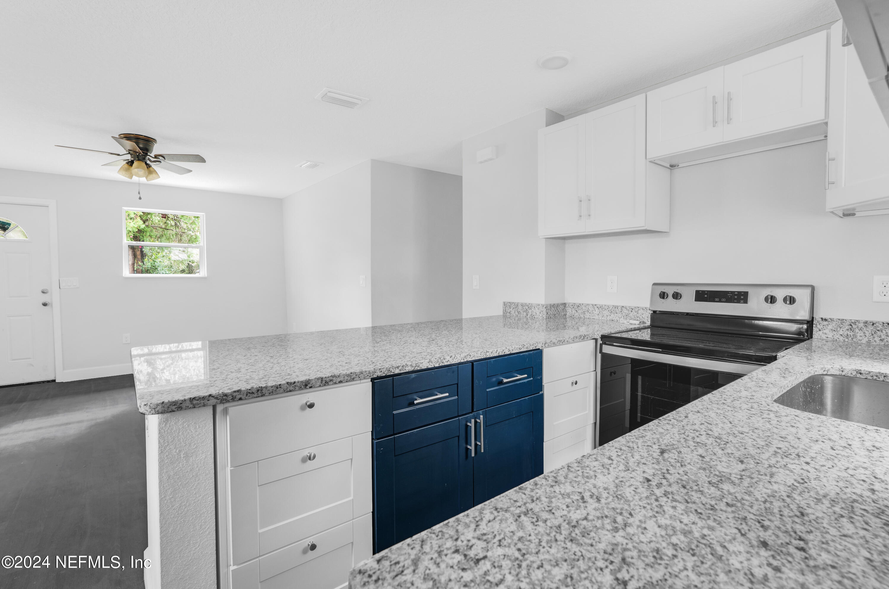 7301 Melvin Road Jacksonville, FL 32210 - Photo 8 of 27 a kitchen with a stove sink and cabinets