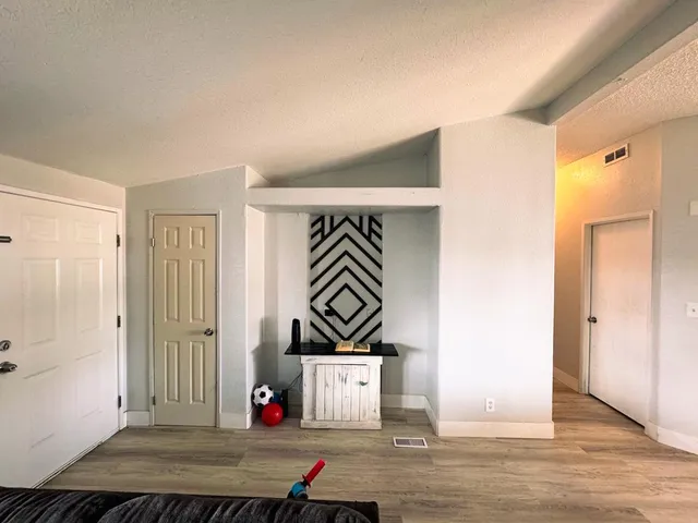 a view of an entryway with wooden floor