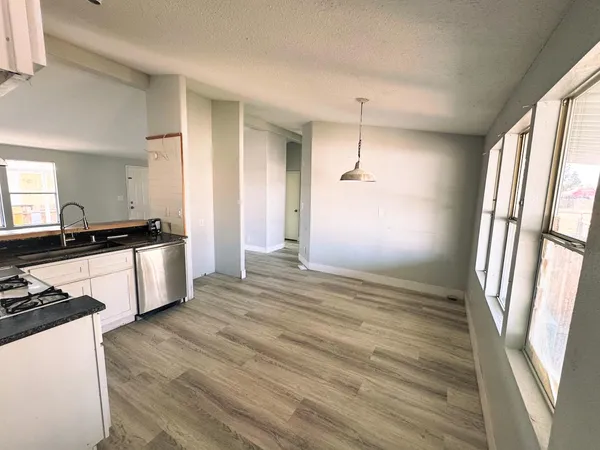a view of a kitchen cabinets a sink and wooden floor