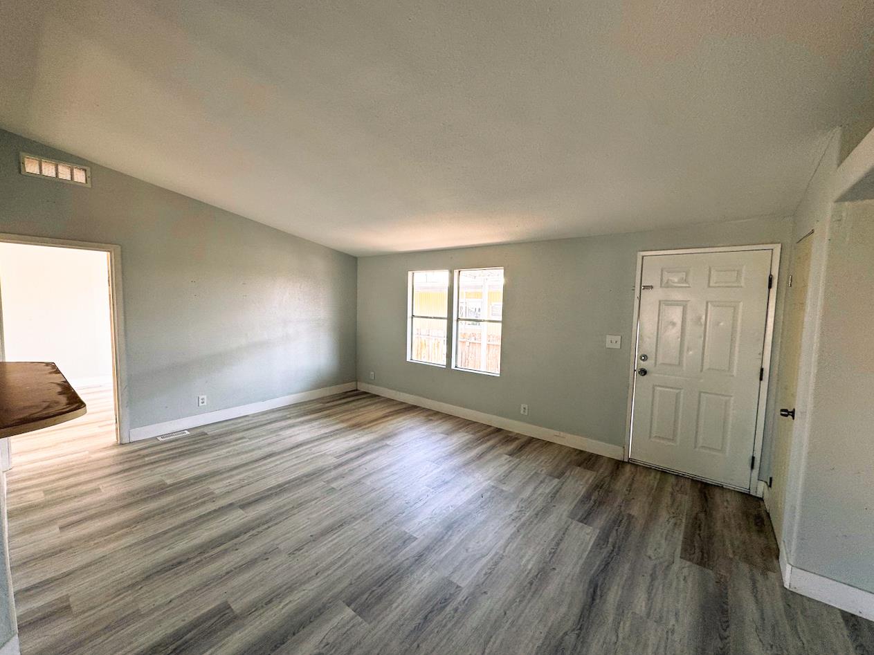 3939 Central Avenue, Unit 35 Ceres, CA 95307 - Photo 18 of 36 a view of an empty room with wooden floor and a window