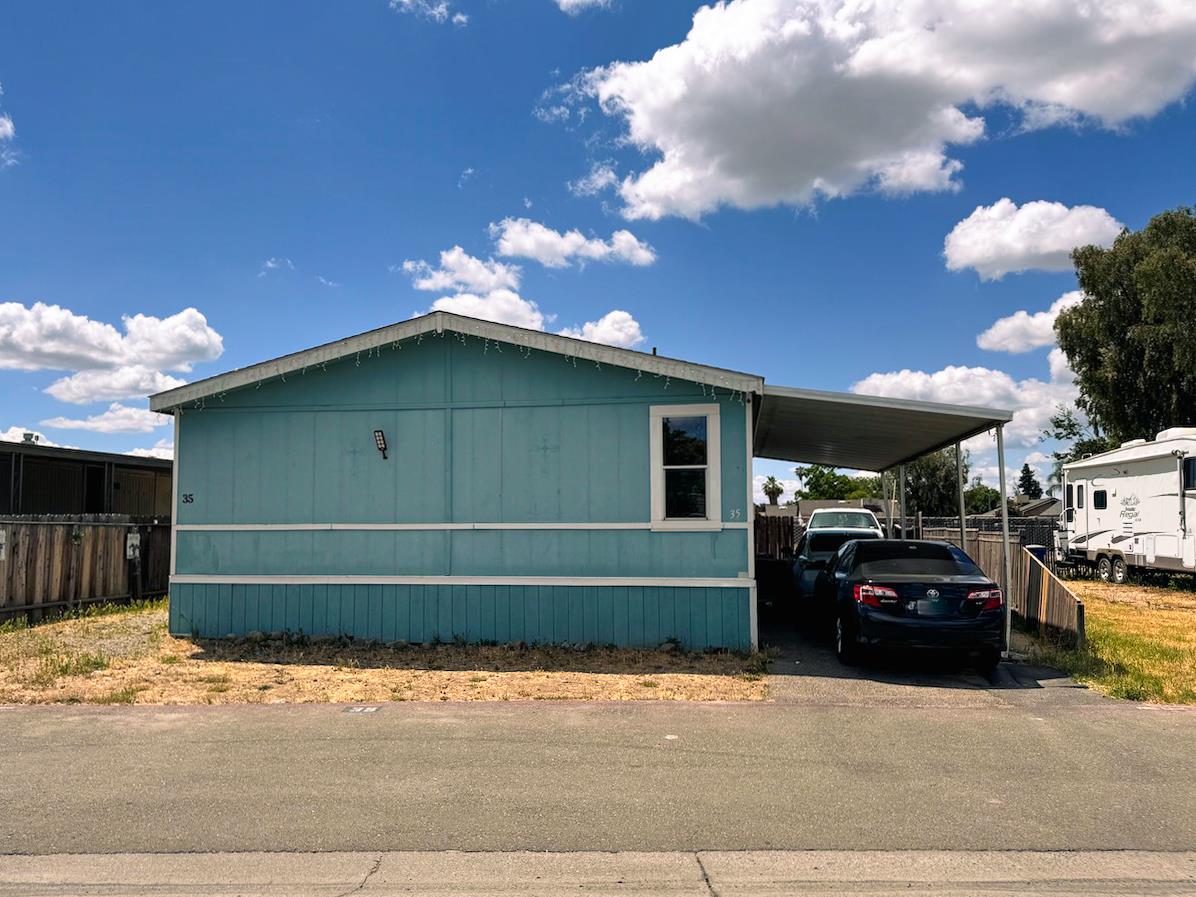 3939 Central Avenue, Unit 35 Ceres, CA 95307 - Photo 2 of 36 a front view of a house with parking space