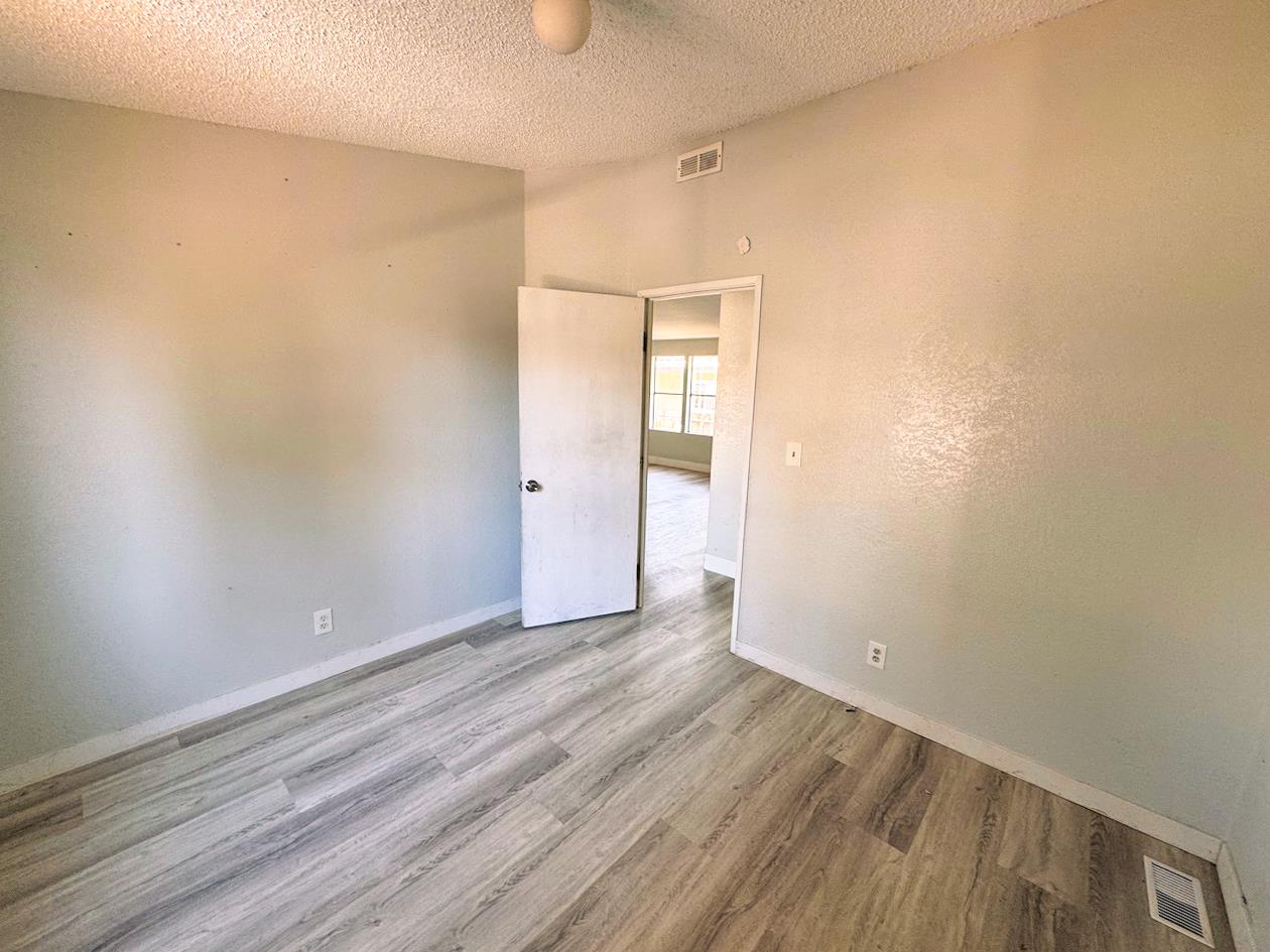3939 Central Avenue, Unit 35 Ceres, CA 95307 - Photo 23 of 36 a view of an empty room with wooden floor