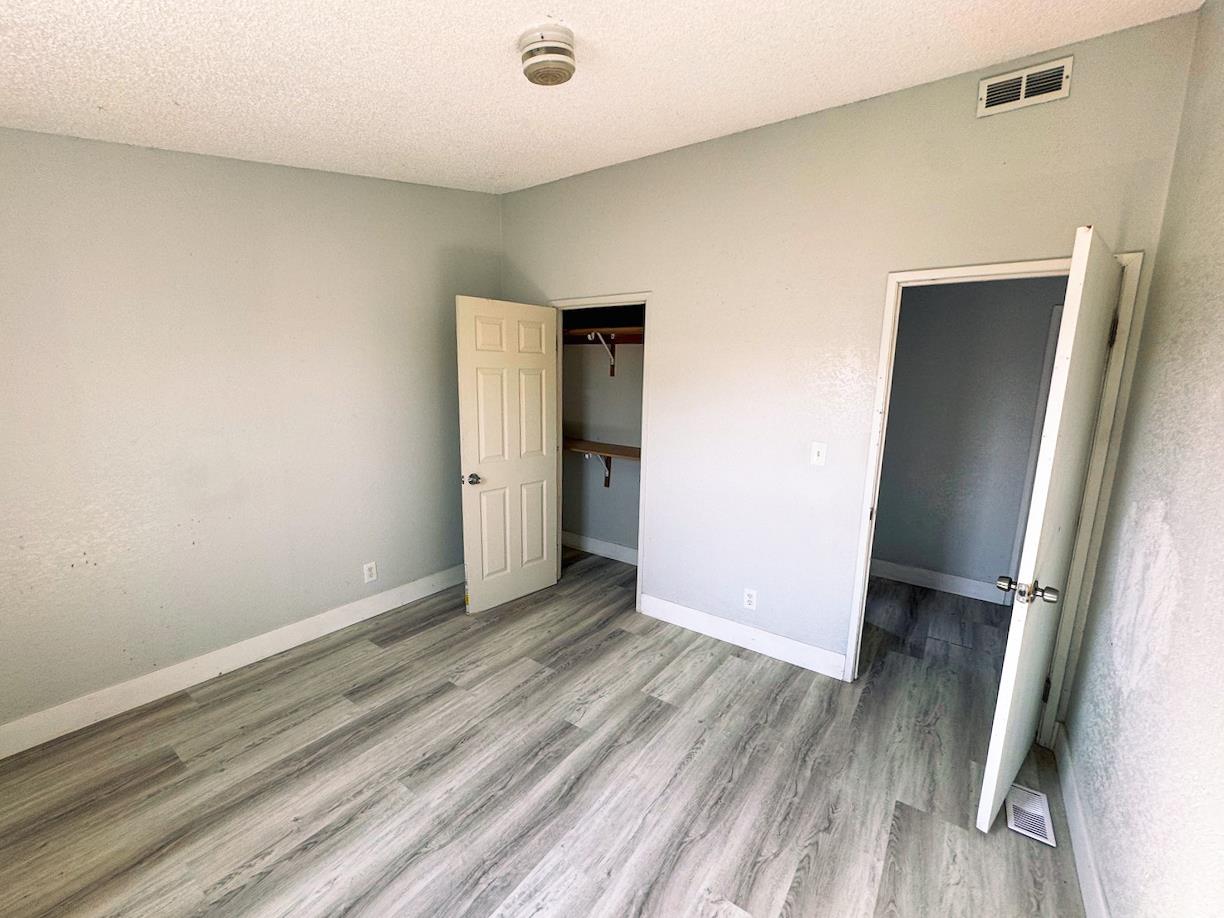 3939 Central Avenue, Unit 35 Ceres, CA 95307 - Photo 24 of 36 an empty room with wooden floor and closet