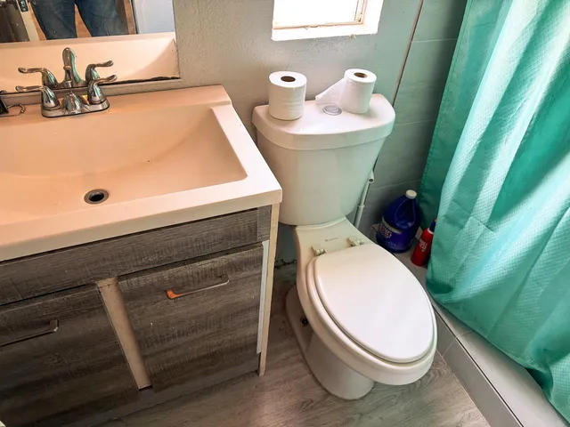 a bathroom with a sink a toilet and a tub