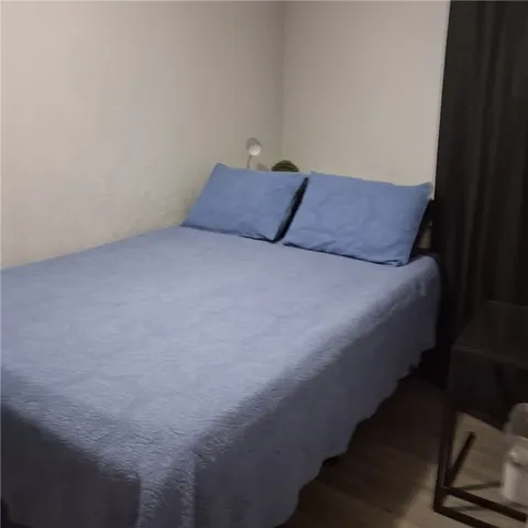 a bed sitting in a bedroom next to a window