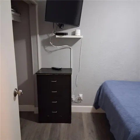 a bedroom with a bed and cabinets