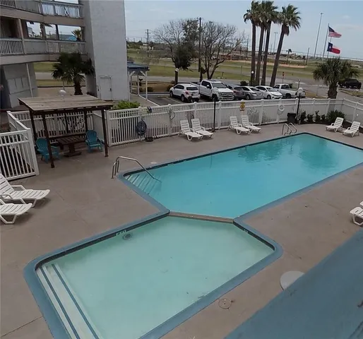 a view of a patio with chairs and plants