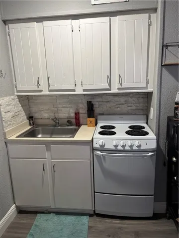 a stove top oven sitting inside of a kitchen