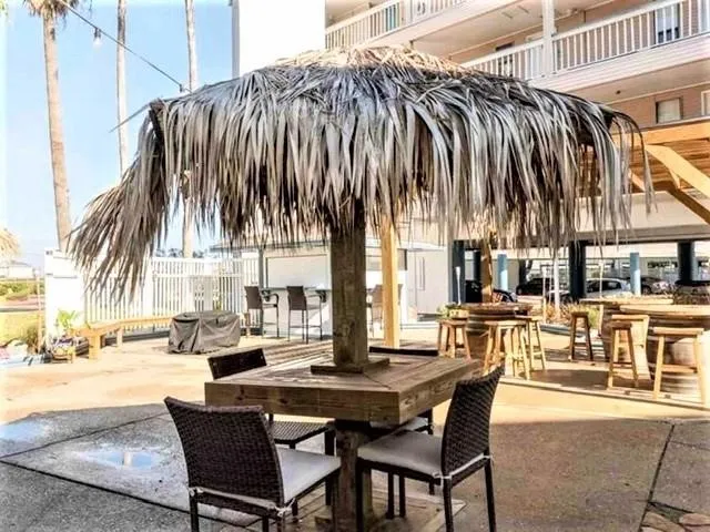 a view of a dinning table and chairs in patio