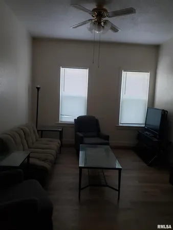 a living room with furniture and a lamp