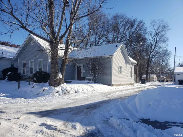 a view of a house with snow on the road