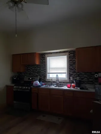 a kitchen with a sink stove and cabinets