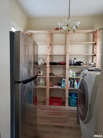 a kitchen with refrigerator and cabinets