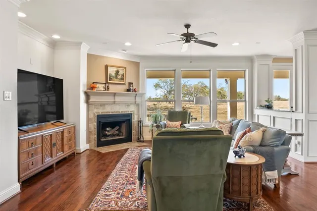 a living room with furniture a flat screen tv and a fireplace