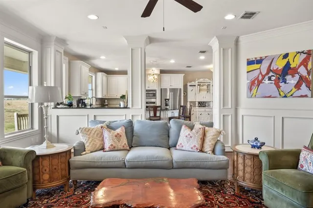 a living room with furniture and kitchen view