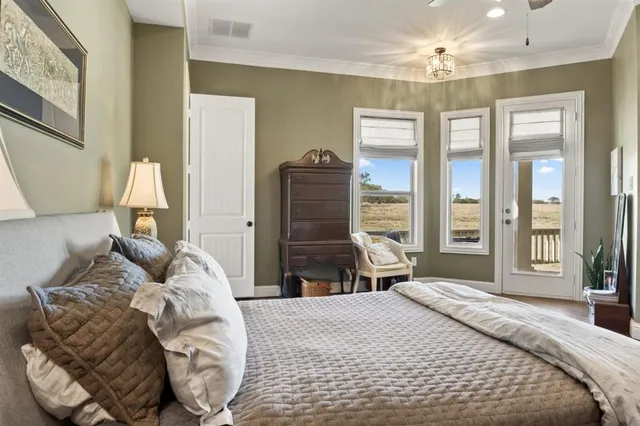 a bedroom with a large bed and a window